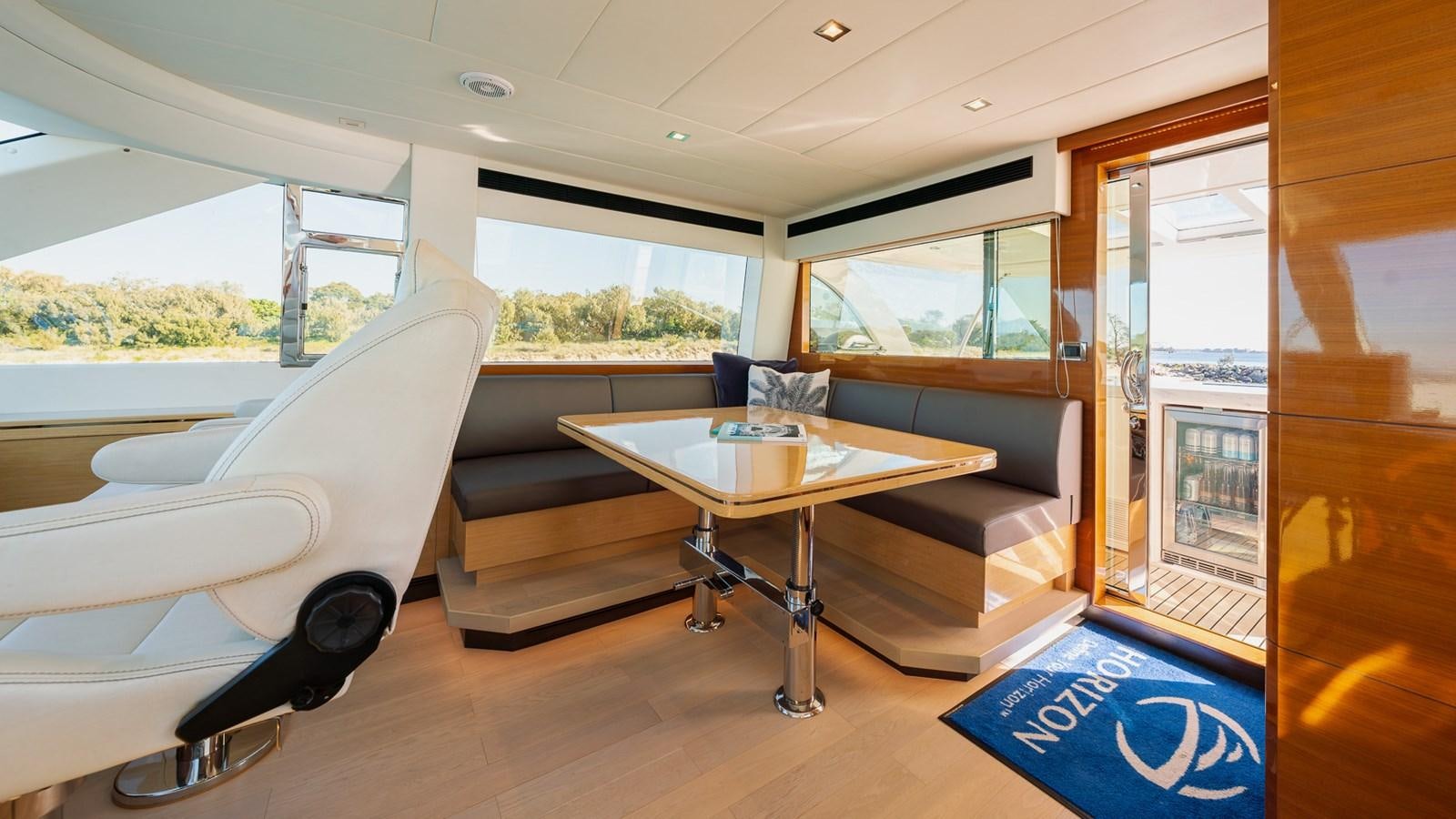 a room with a couch and a table aboard OHANA Yacht for Sale