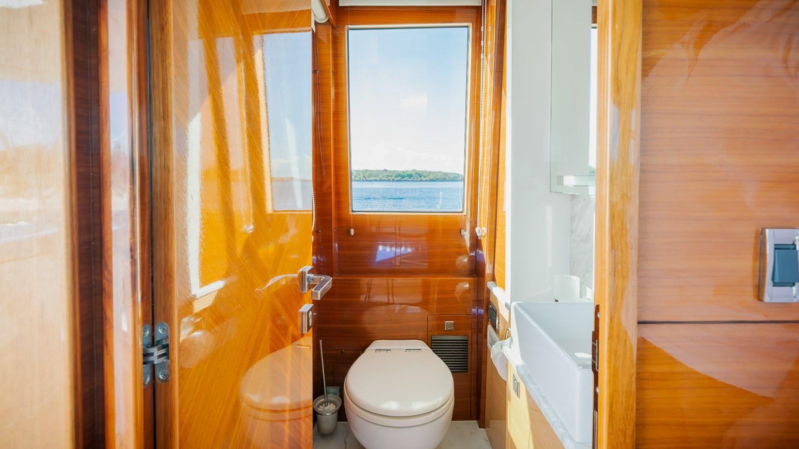 a bathroom with a toilet and a sink aboard OHANA Yacht for Sale