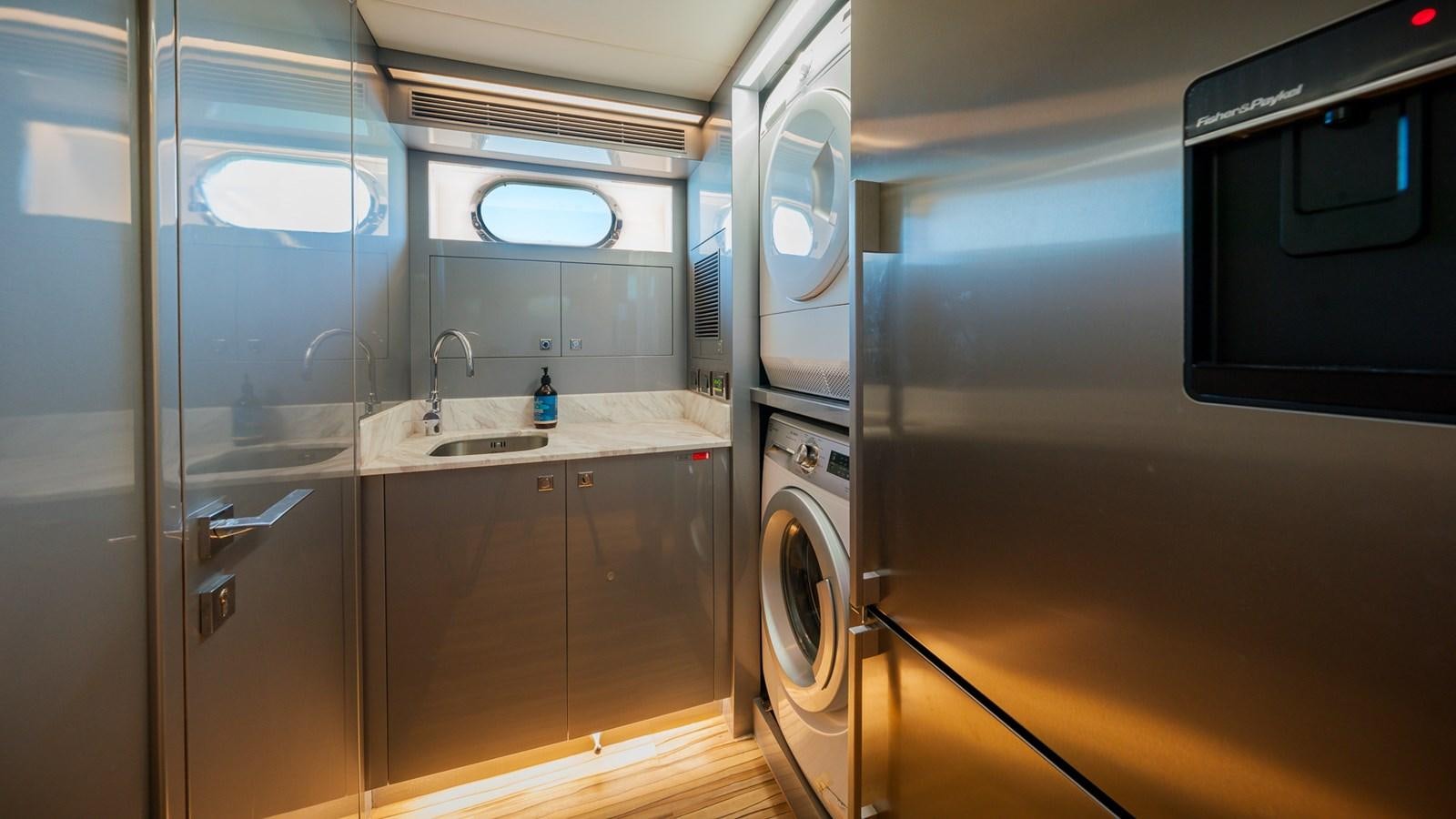 a bathroom with a washer and dryer aboard OHANA Yacht for Sale