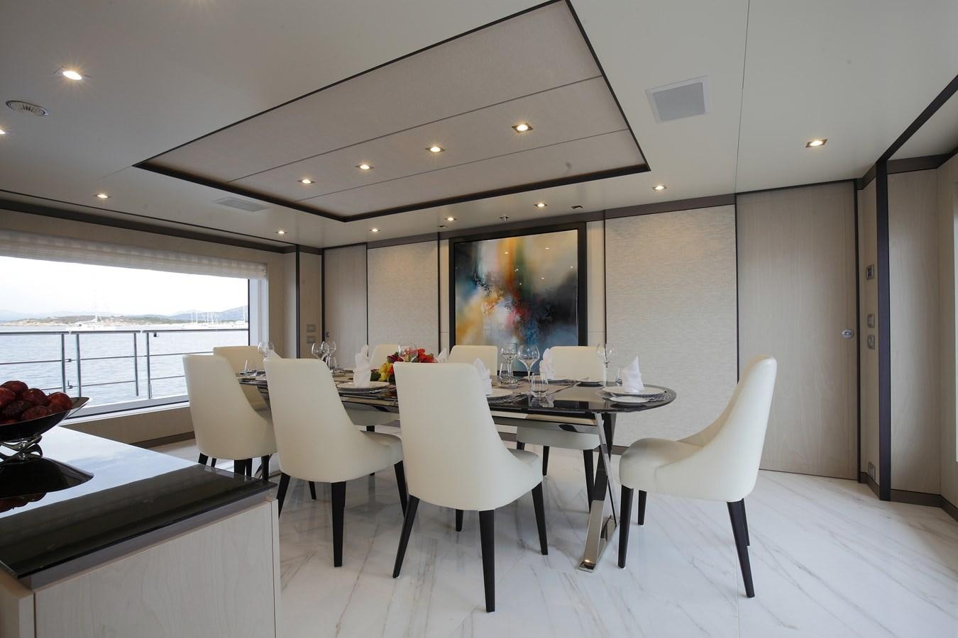 a room with white chairs and a table with white chairs aboard WILLOW Yacht for Sale