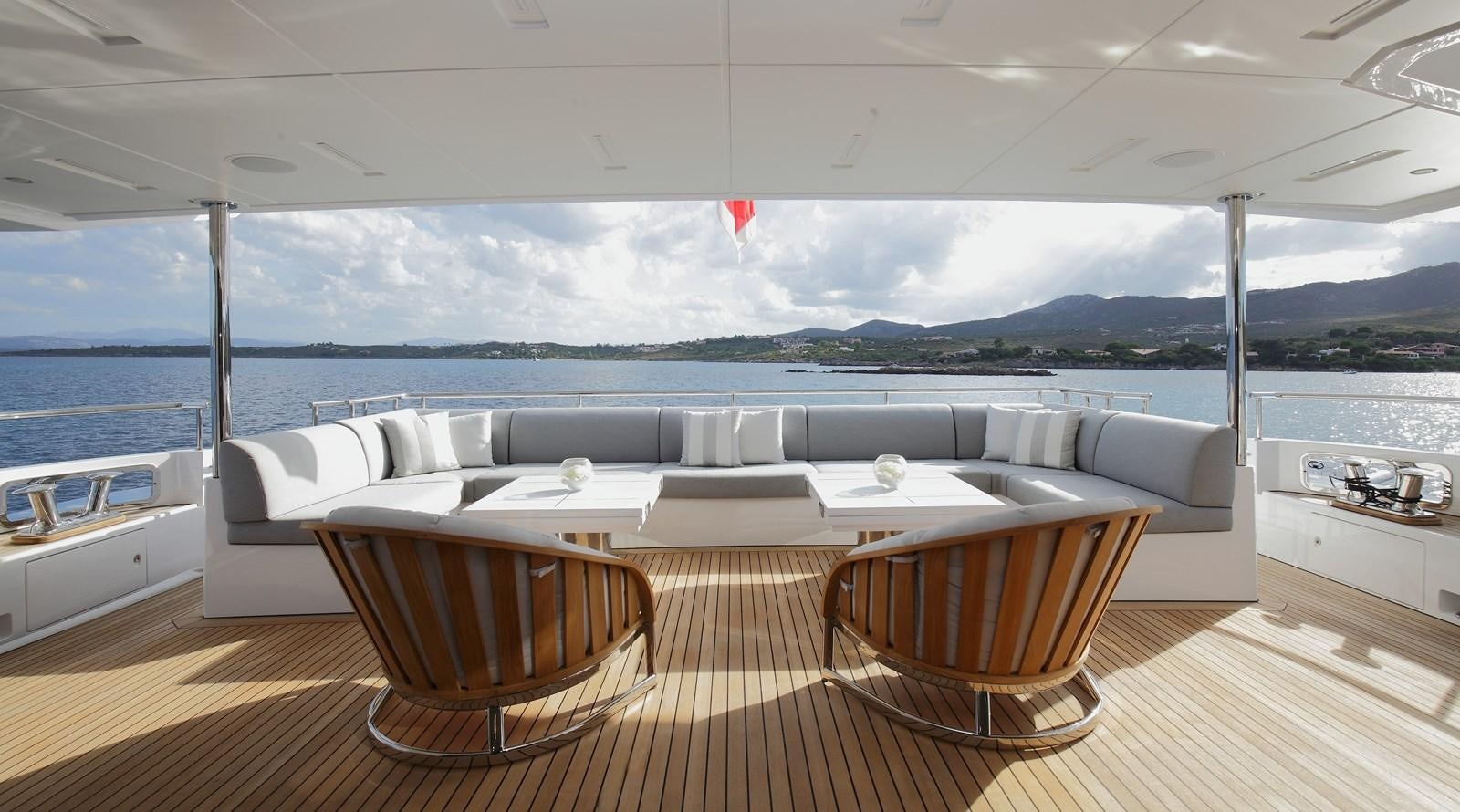 a large room with a couch and a table and chairs aboard WILLOW Yacht for Sale