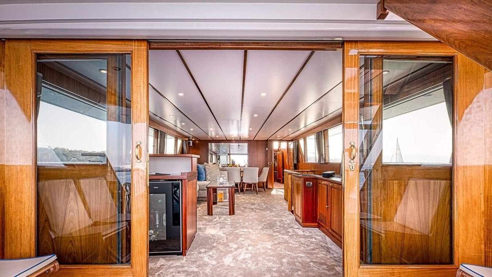 a room with a fireplace and a large window aboard CHANTELLA Yacht for Sale