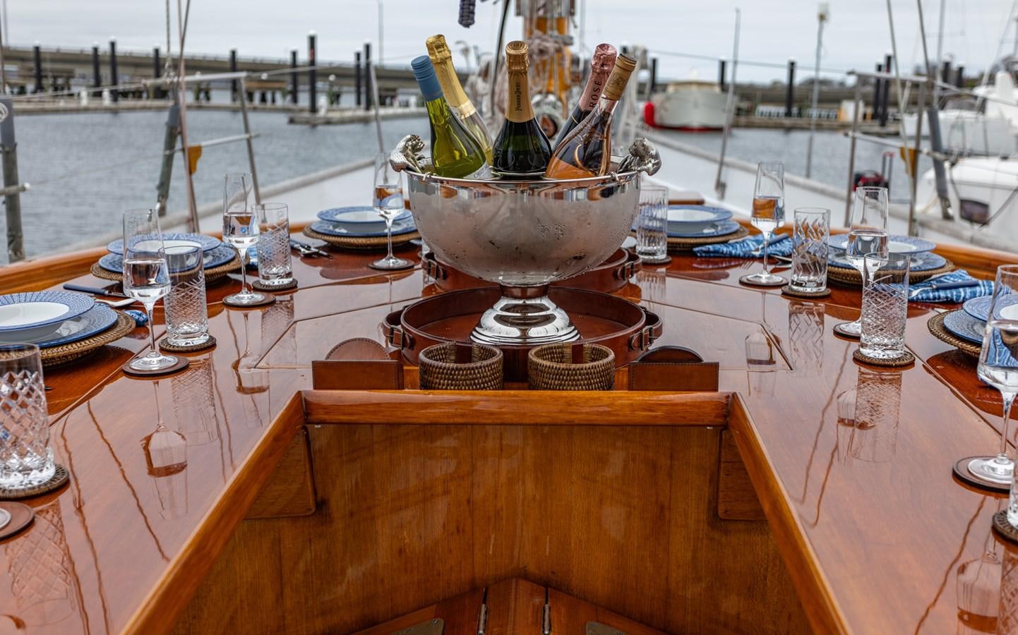 a table with wine bottles and glasses on it aboard HERMITAGE Yacht for Sale