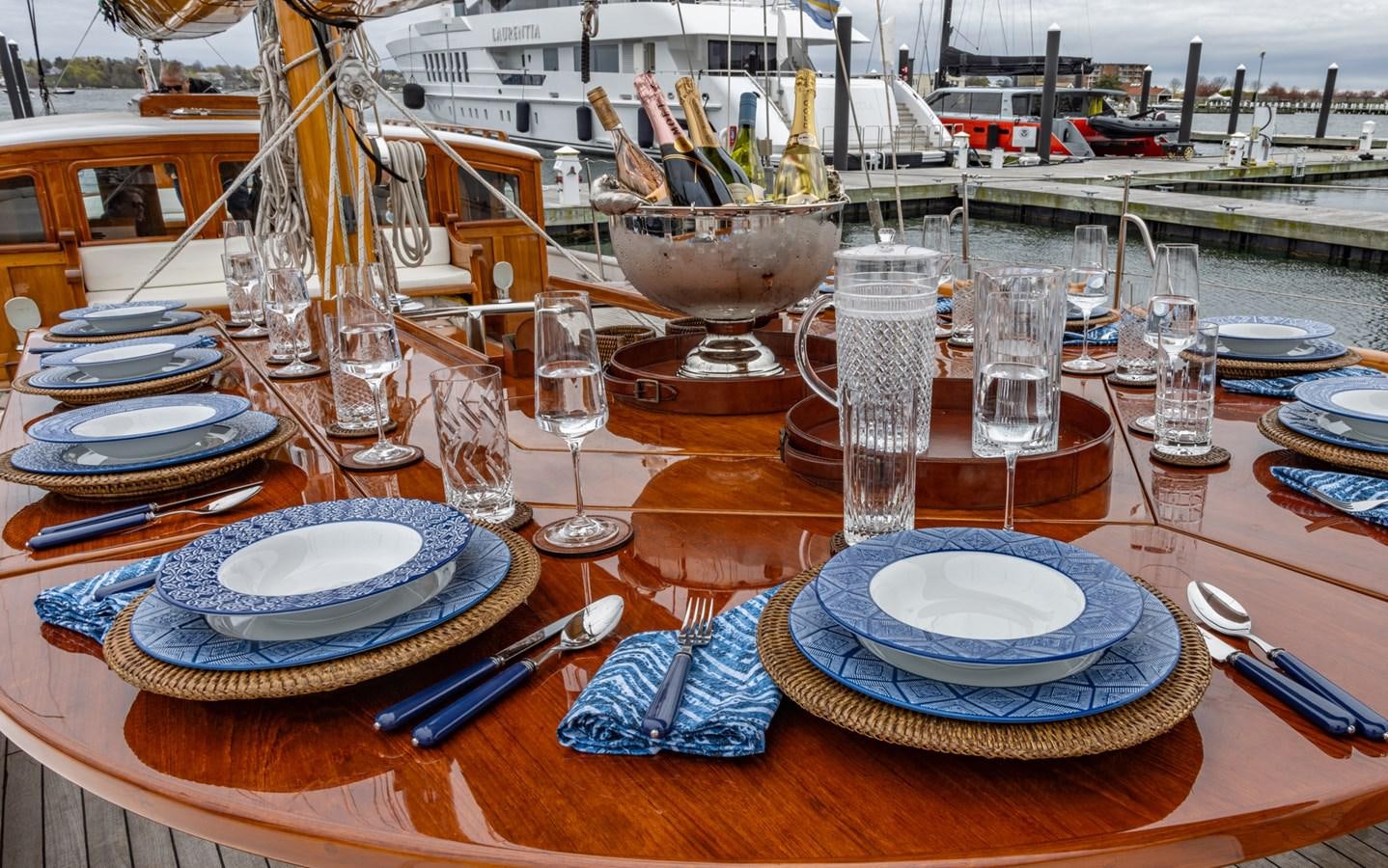 a table with plates and glasses aboard HERMITAGE Yacht for Sale