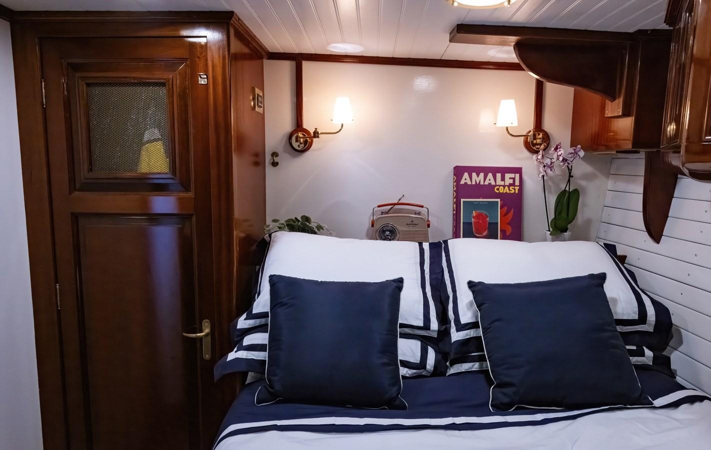 a bed with white sheets and pillows aboard HERMITAGE Yacht for Sale