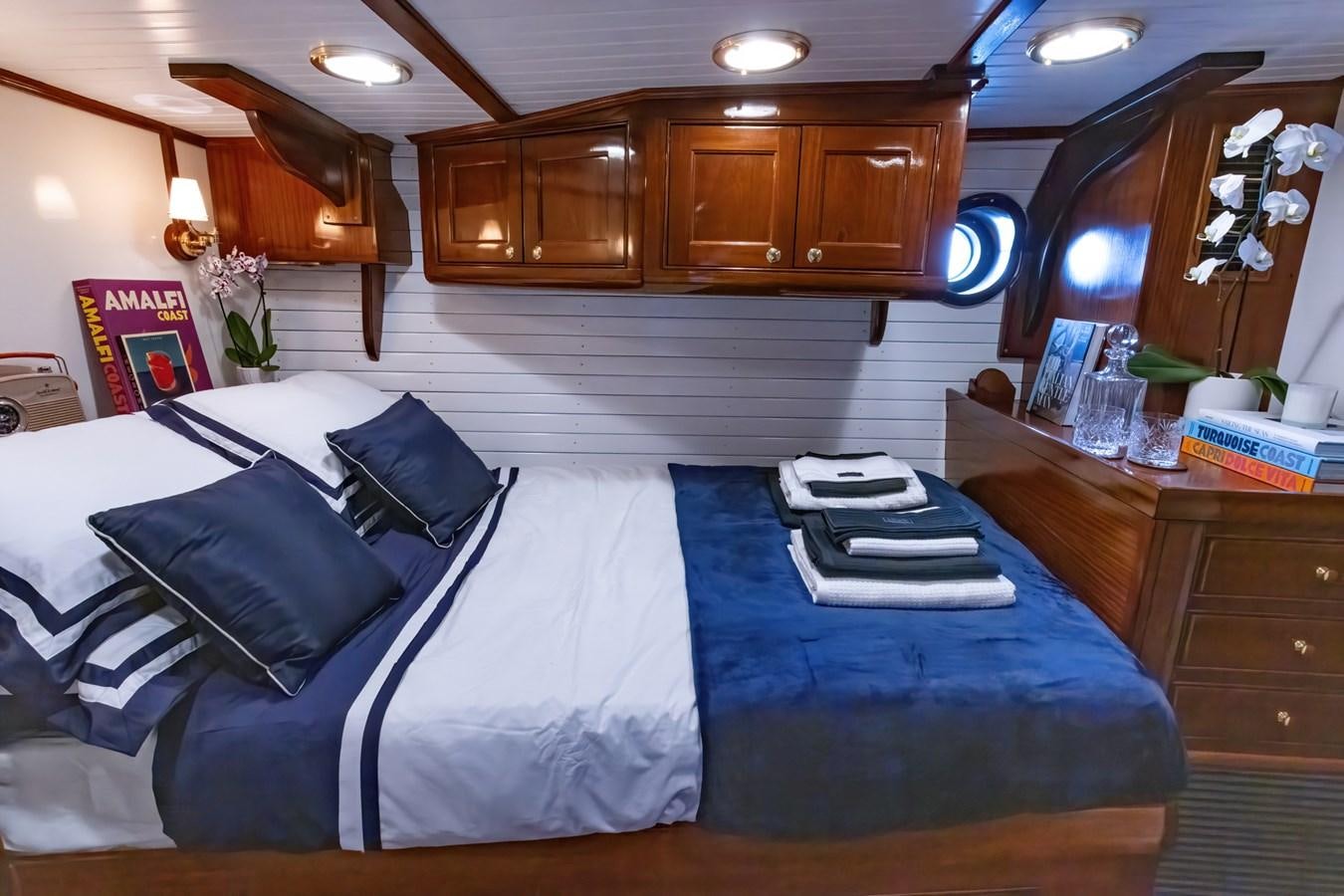 a bed with a blue sheet aboard HERMITAGE Yacht for Sale