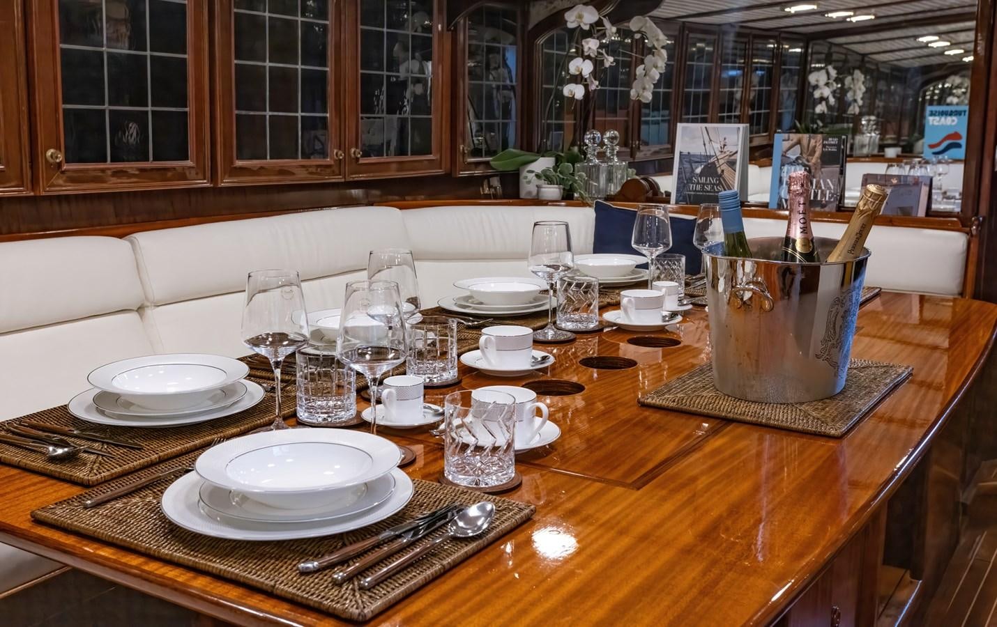 a table with plates and glasses on it aboard HERMITAGE Yacht for Sale