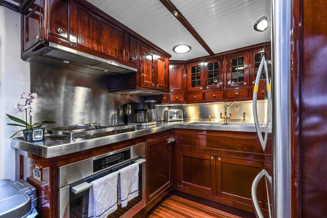 a kitchen with wooden cabinets aboard HERMITAGE Yacht for Sale