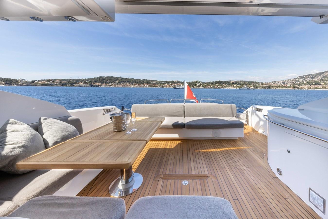 a deck with a view of the water and a beach aboard STAR OF SEVEN SEAS Yacht for Sale