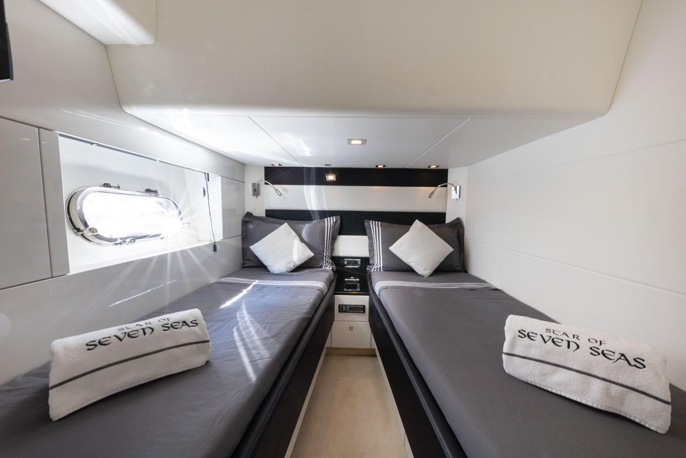 a room with a bed and a desk aboard STAR OF SEVEN SEAS Yacht for Sale