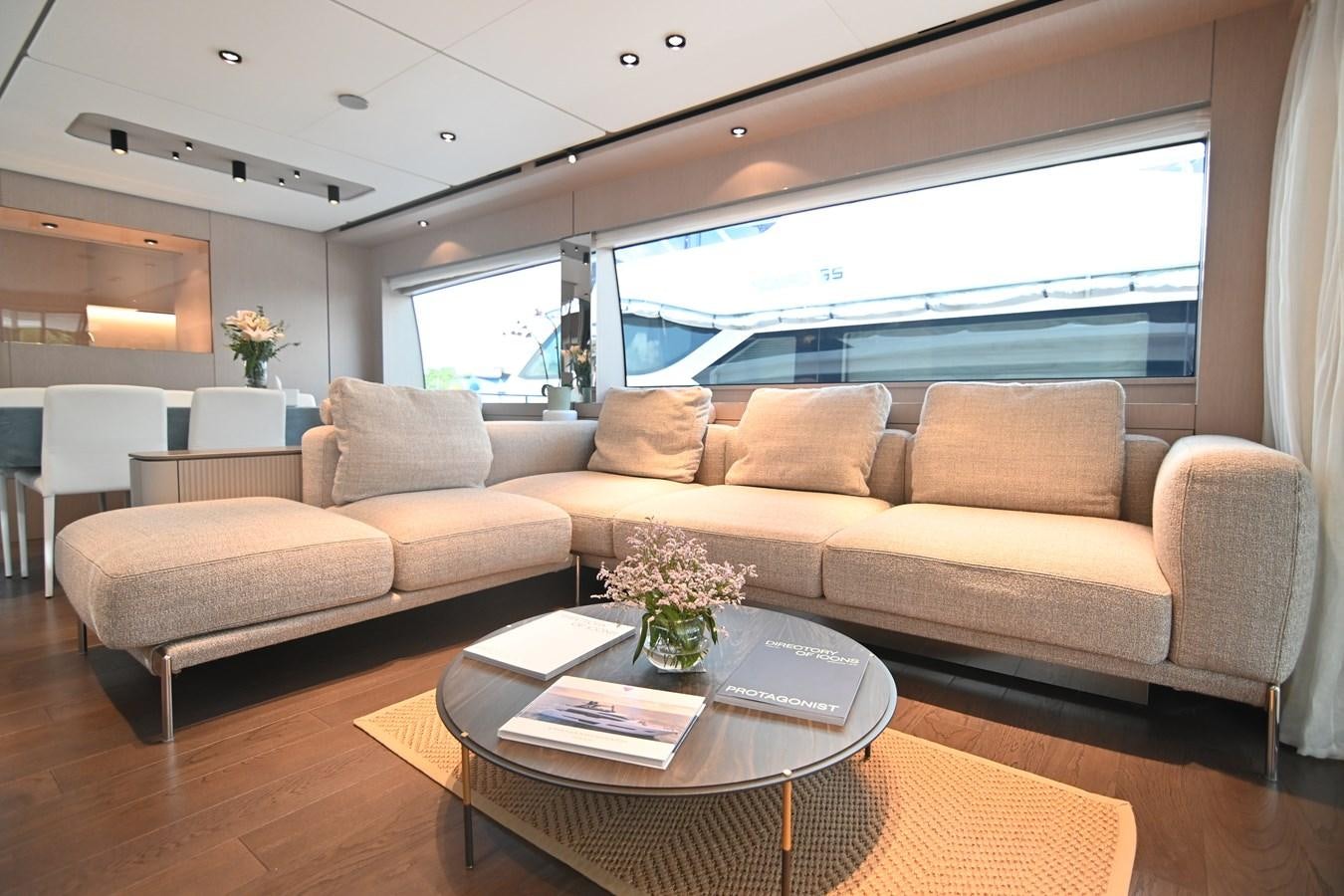 a living room with a large window aboard JOYOUS JOURNEY Yacht for Sale