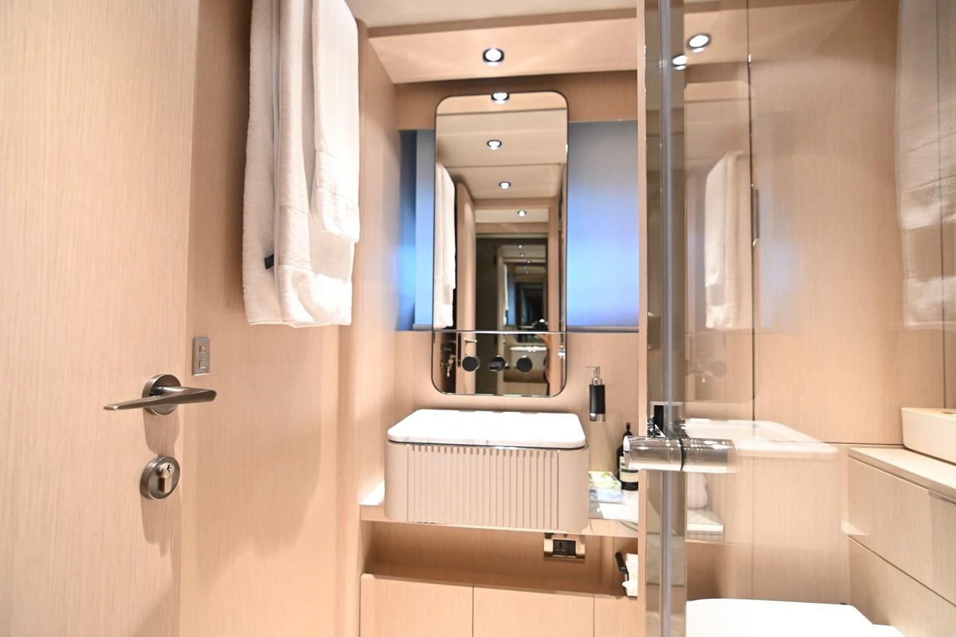 a bathroom with a mirror and a sink aboard JOYOUS JOURNEY Yacht for Sale