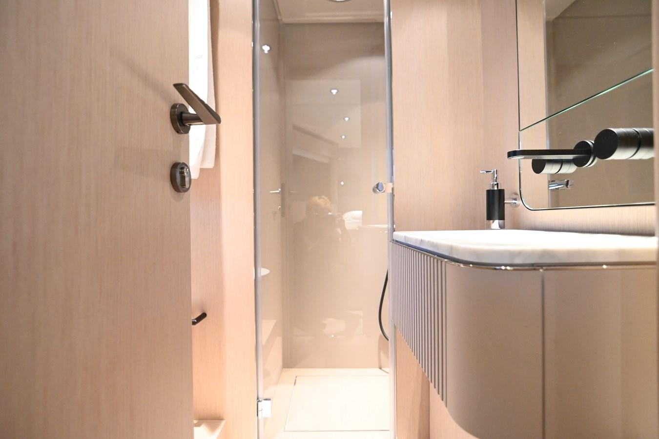 a bathroom with a sink and a shower aboard JOYOUS JOURNEY Yacht for Sale