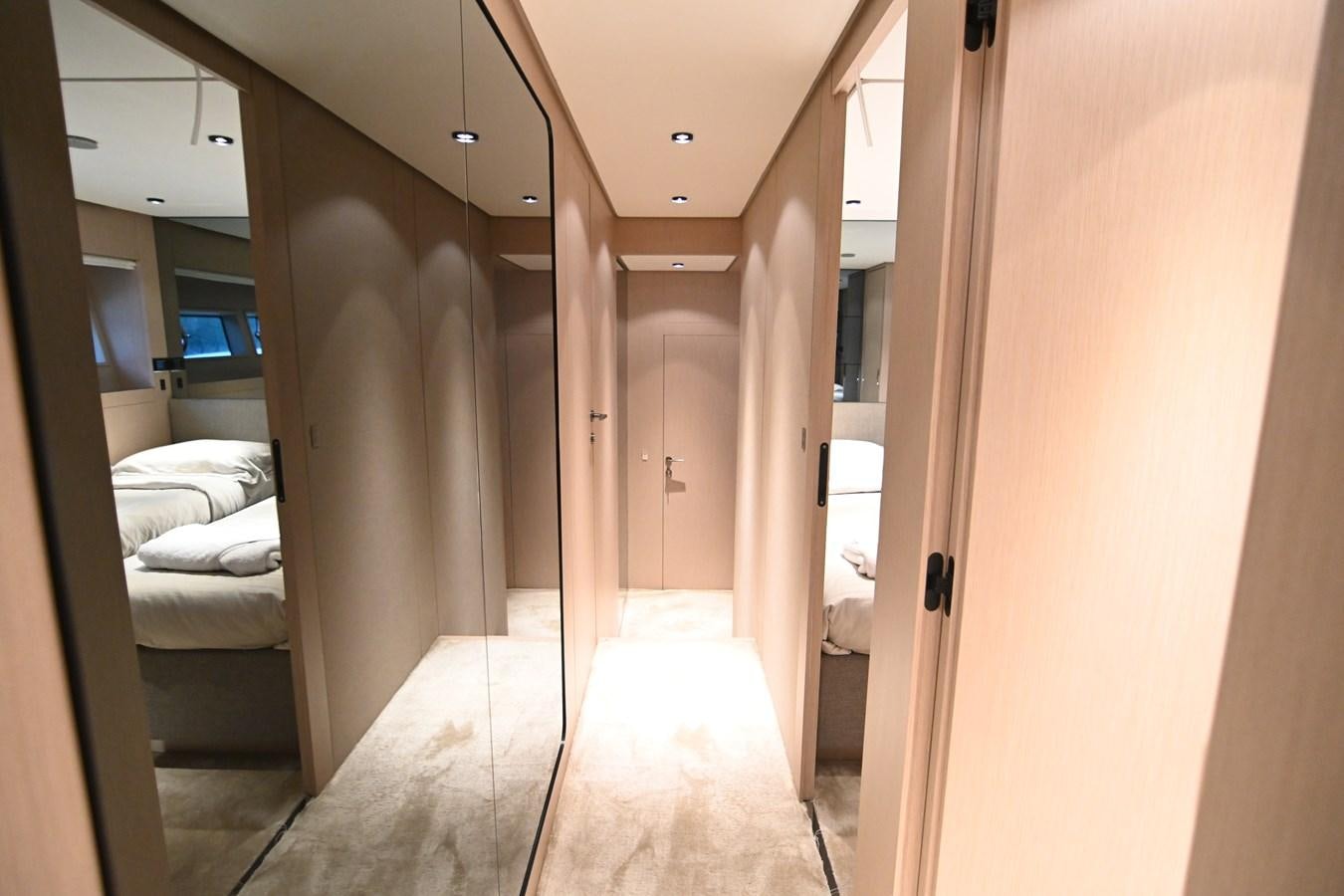 a room with a bed and a door aboard JOYOUS JOURNEY Yacht for Sale