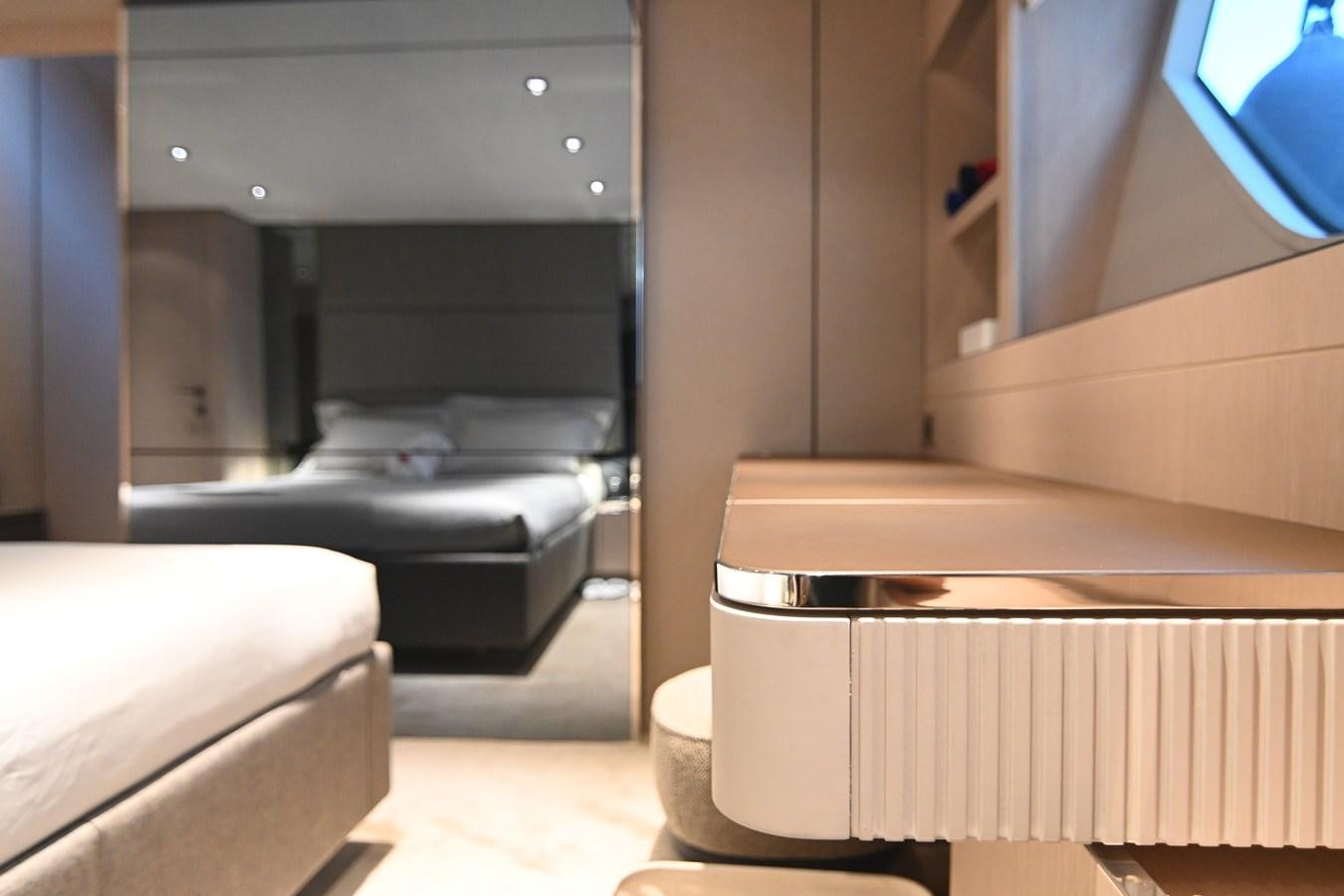 a room with a bed and a desk aboard JOYOUS JOURNEY Yacht for Sale