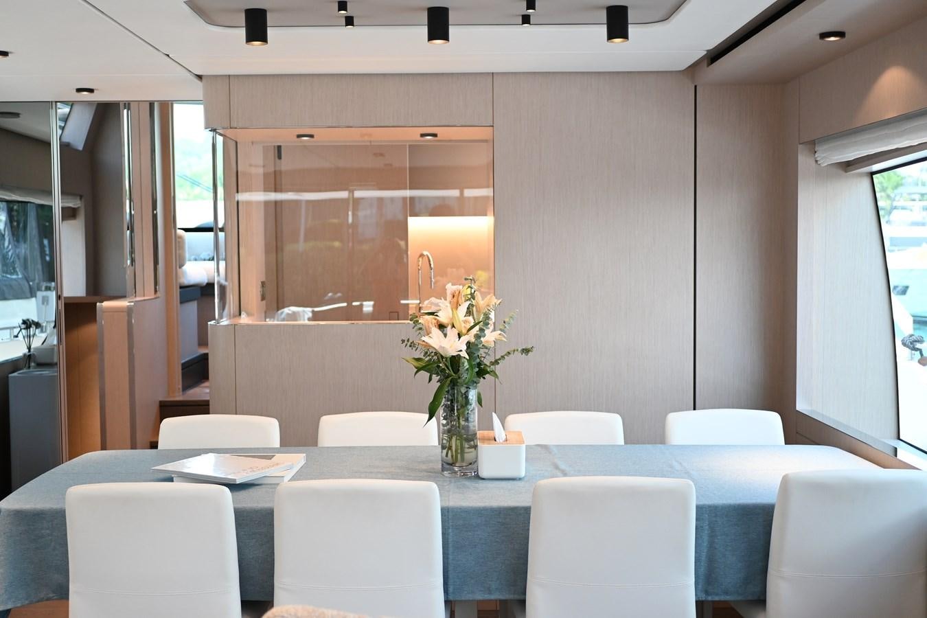 a table with white chairs and white chairs aboard JOYOUS JOURNEY Yacht for Sale