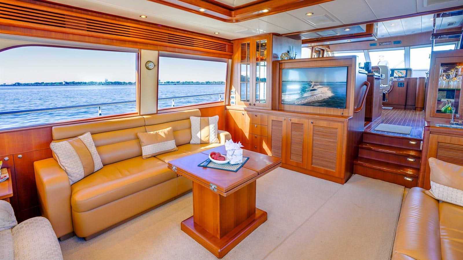 a living room with a couch and a tv aboard CAVALLINO III Yacht for Sale