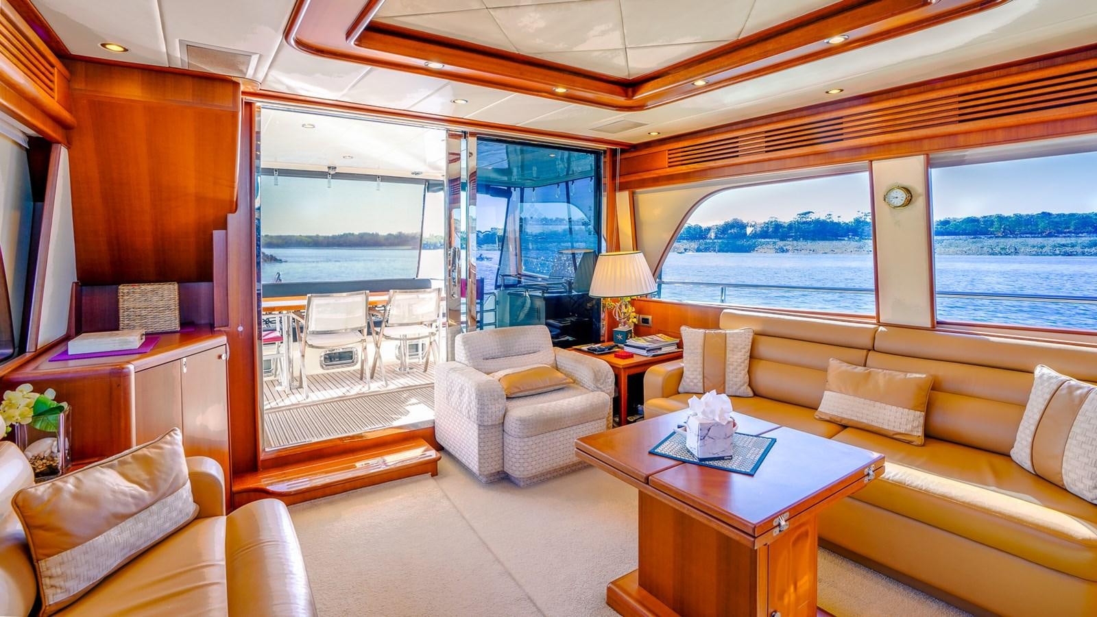 a living room with a large window aboard CAVALLINO III Yacht for Sale
