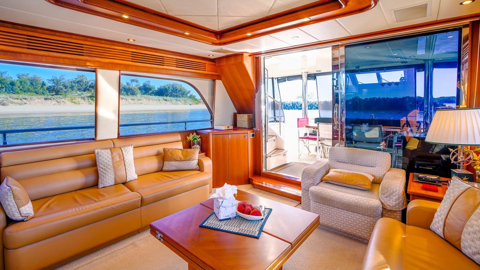a living room with a large window aboard CAVALLINO III Yacht for Sale