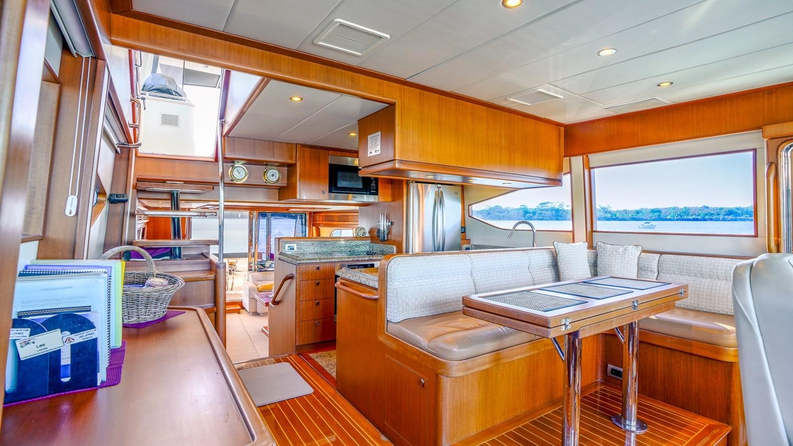 a kitchen with a table and chairs aboard CAVALLINO III Yacht for Sale
