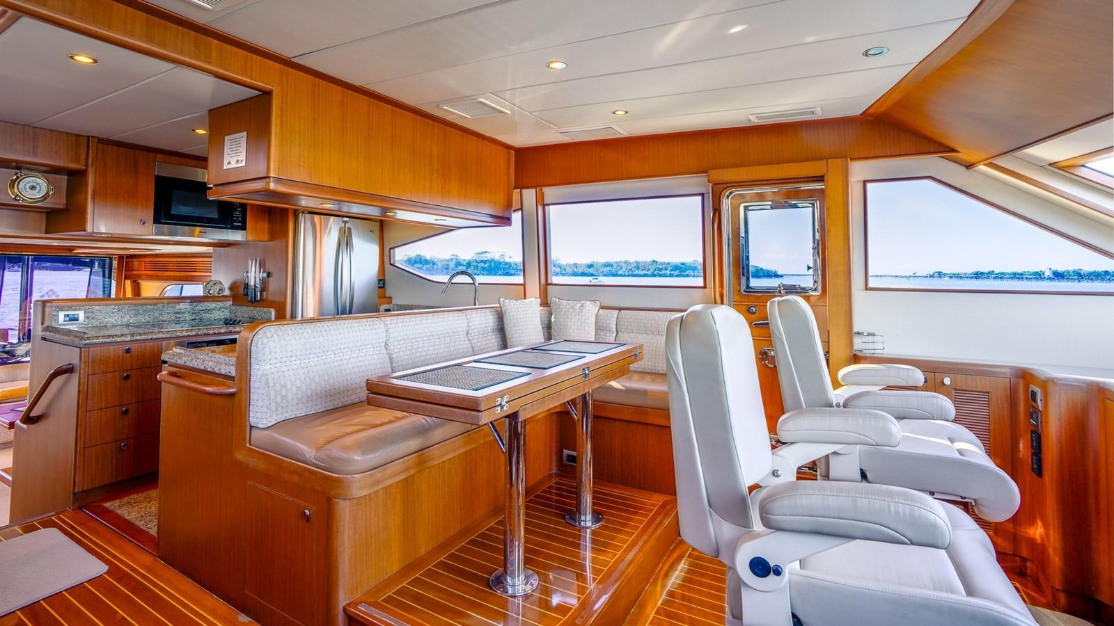 a room with a table and chairs aboard CAVALLINO III Yacht for Sale