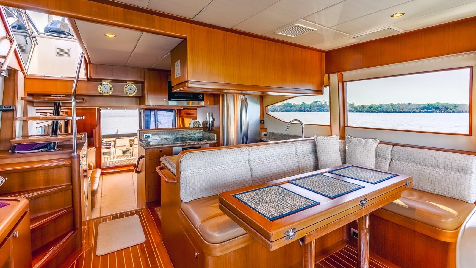 a room with a couch and a table aboard CAVALLINO III Yacht for Sale