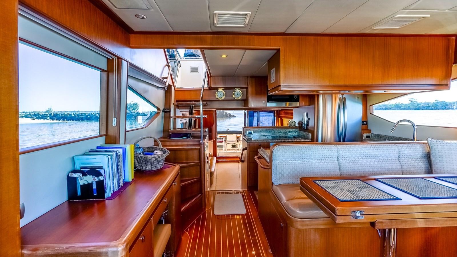 a kitchen with a table and chairs aboard CAVALLINO III Yacht for Sale
