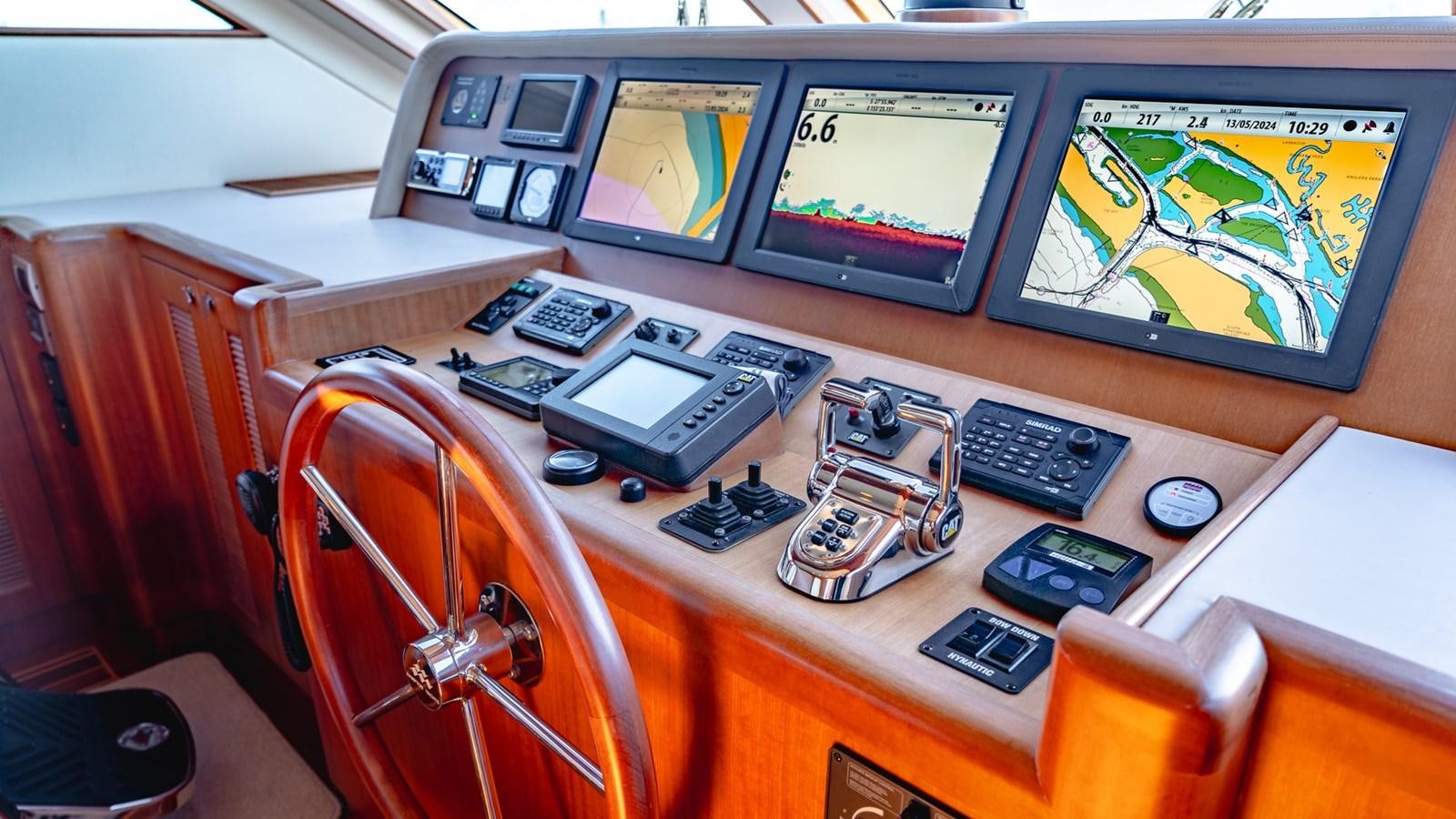 a table with electronics and a computer aboard CAVALLINO III Yacht for Sale