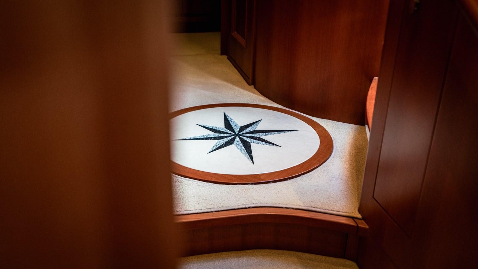 a white and blue flower on a brown box aboard CAVALLINO III Yacht for Sale