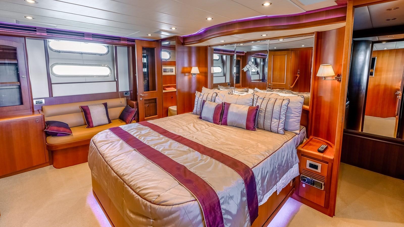 a bedroom with a bed and a couch aboard CAVALLINO III Yacht for Sale