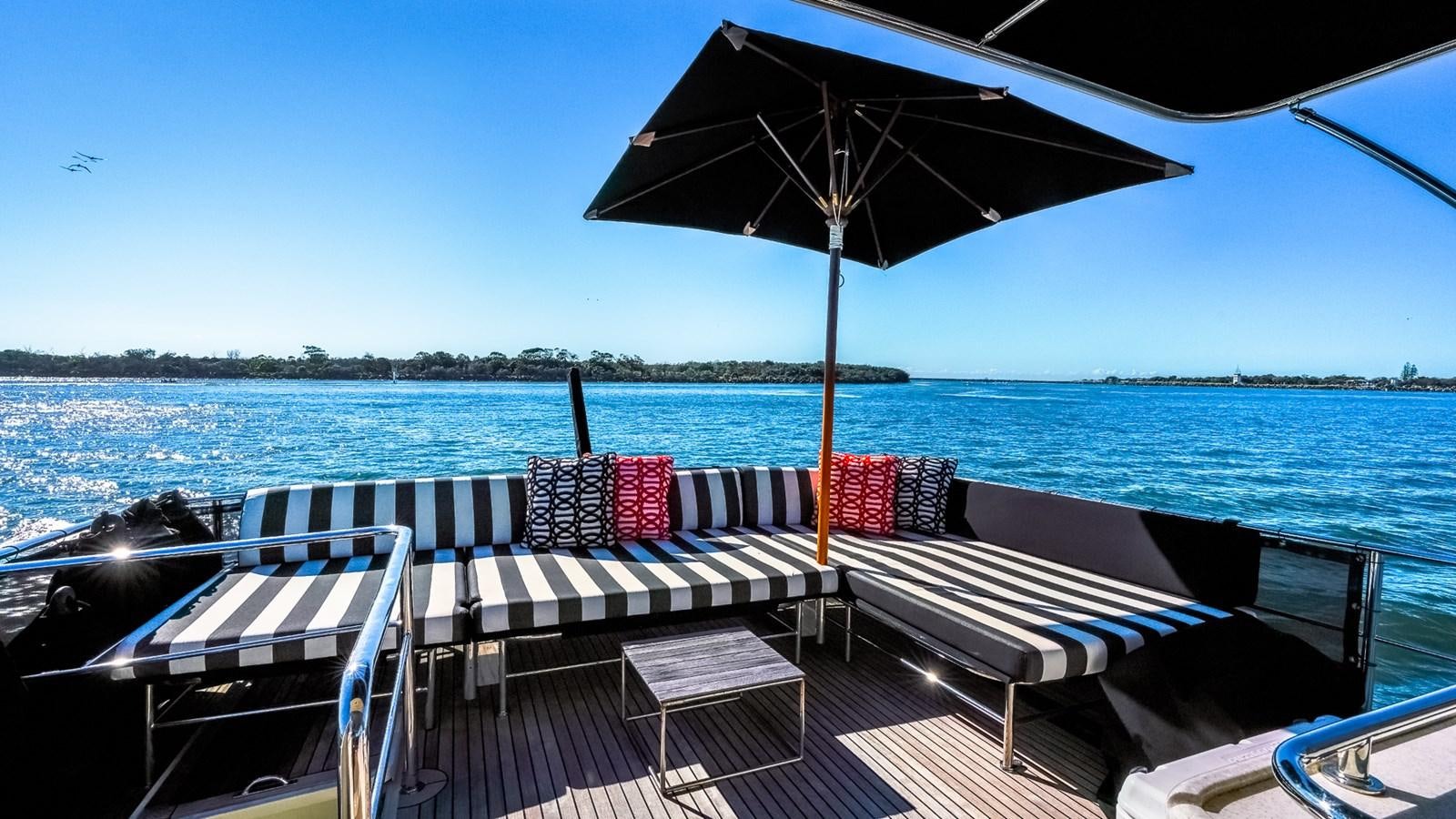 a deck with chairs and umbrellas on it aboard CAVALLINO III Yacht for Sale