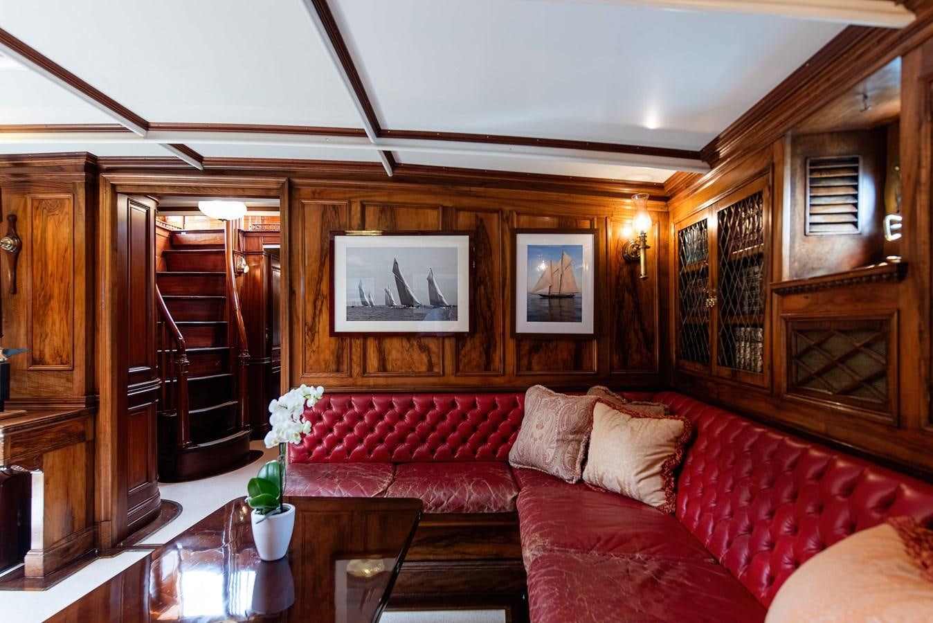 a living room with a red couch aboard MARIETTE OF 1915 Yacht for Sale