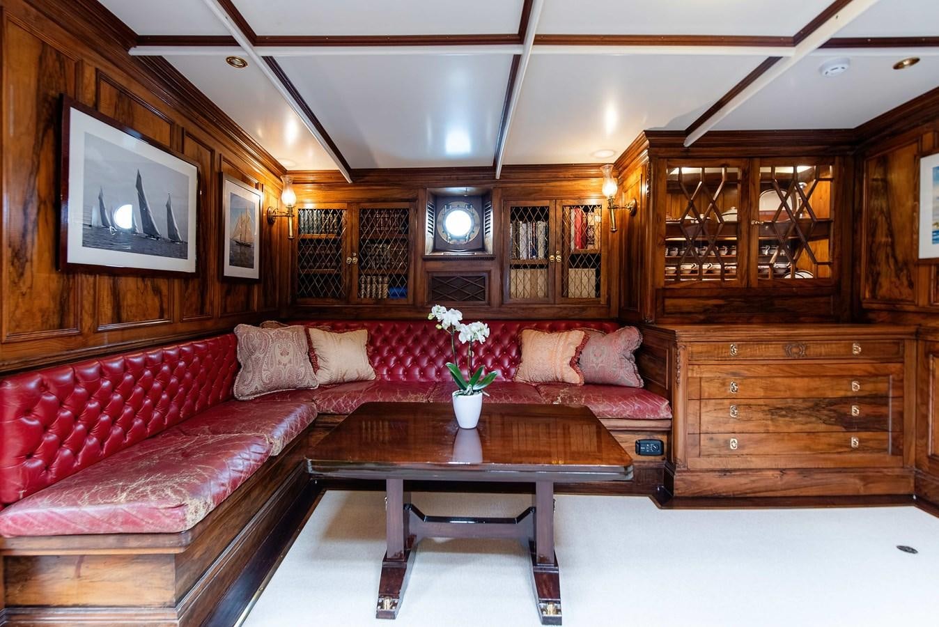 a living room with a red couch aboard MARIETTE OF 1915 Yacht for Sale