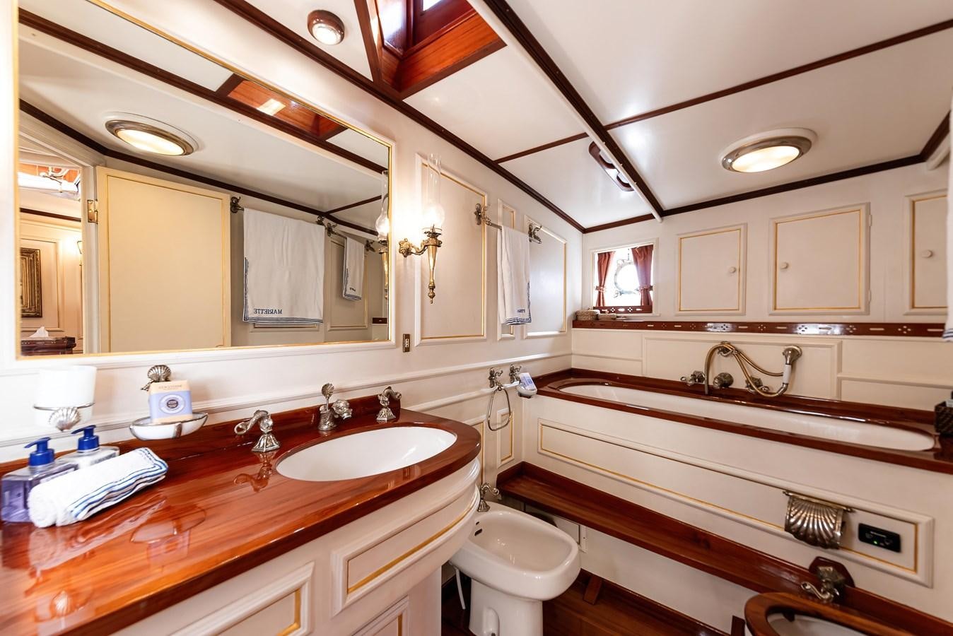 a bathroom with a large mirror aboard MARIETTE OF 1915 Yacht for Sale