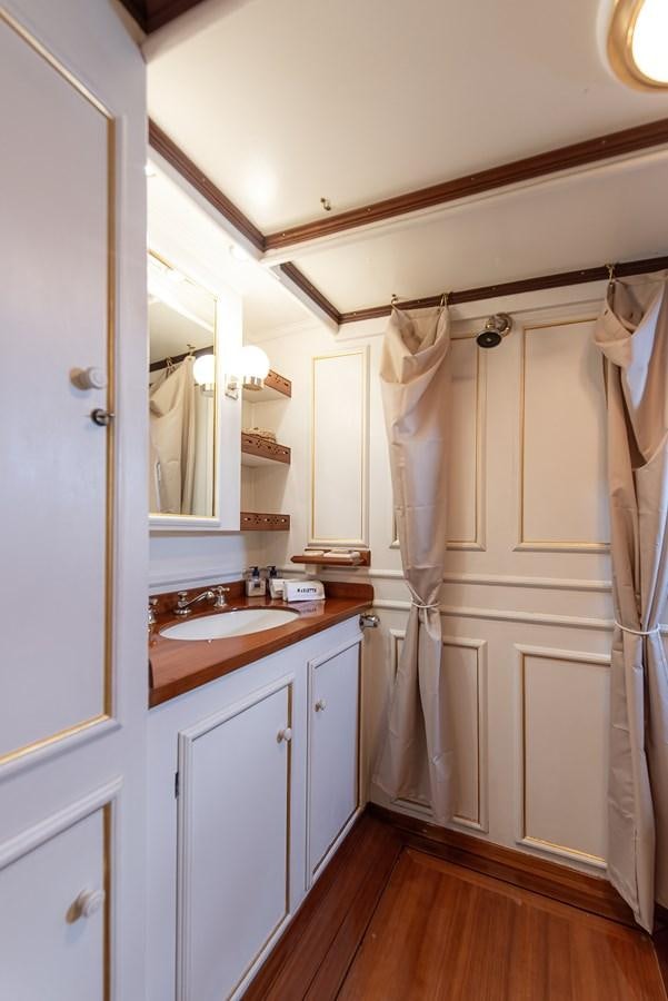 a bathroom with a sink and a mirror aboard MARIETTE OF 1915 Yacht for Sale
