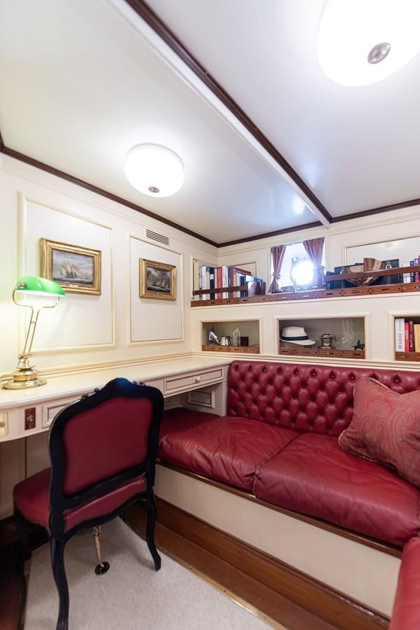 a living room with a red couch aboard MARIETTE OF 1915 Yacht for Sale