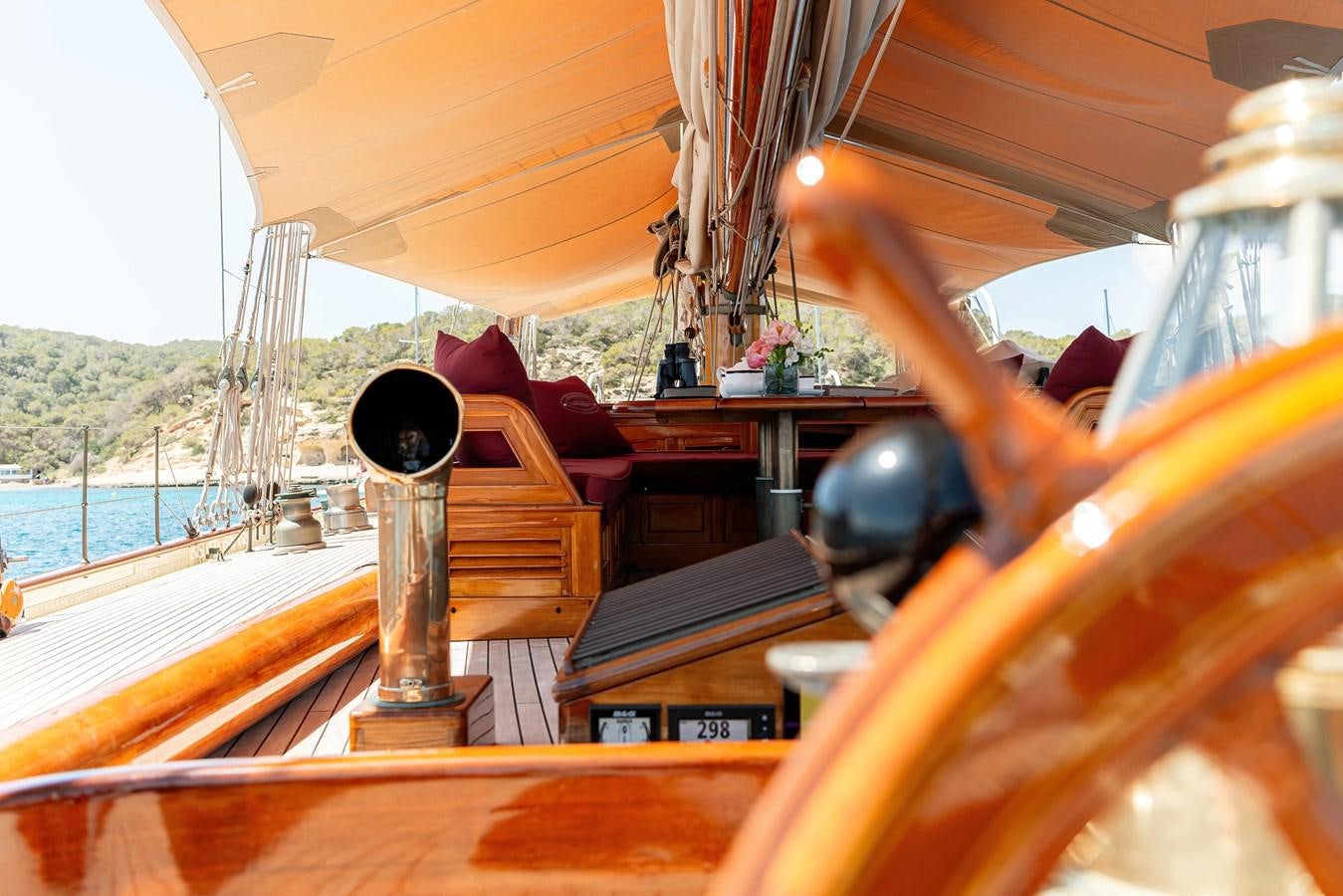 a person pouring a drink into a glass on a boat aboard MARIETTE OF 1915 Yacht for Sale