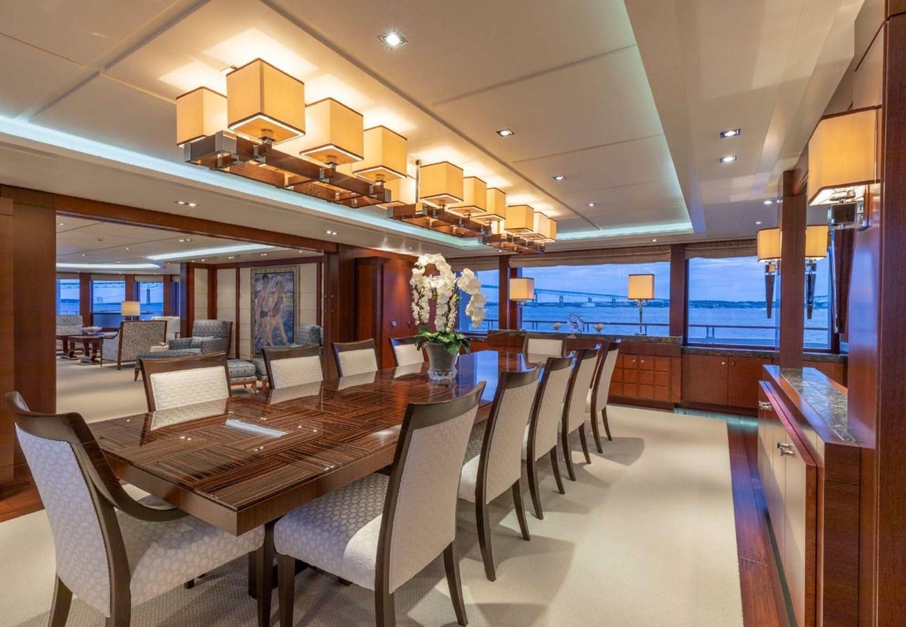 a room with tables and chairs aboard BELLA VITA Yacht for Sale