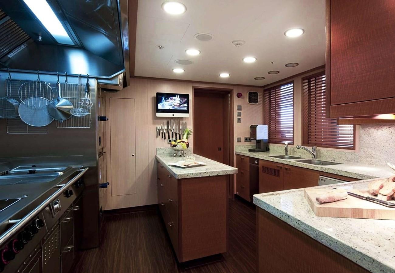 a kitchen with a wood floor aboard BELLA VITA Yacht for Sale