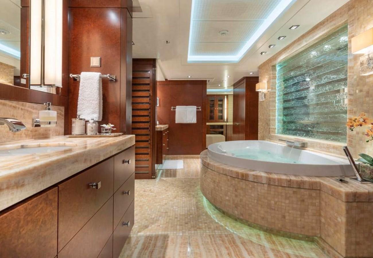 a bathroom with a tub sink and a shower unit aboard BELLA VITA Yacht for Sale