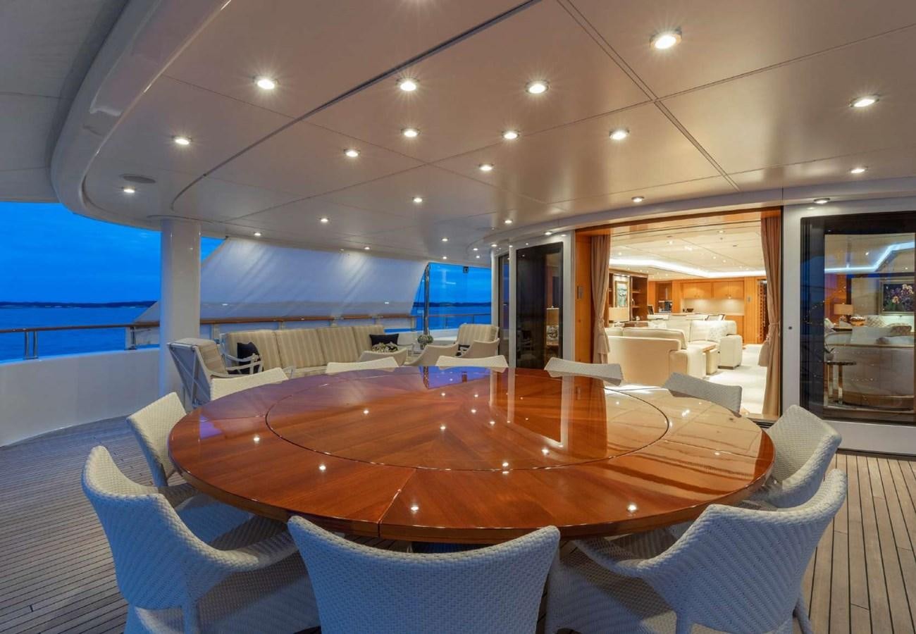 a large room with a table and chairs aboard BELLA VITA Yacht for Sale