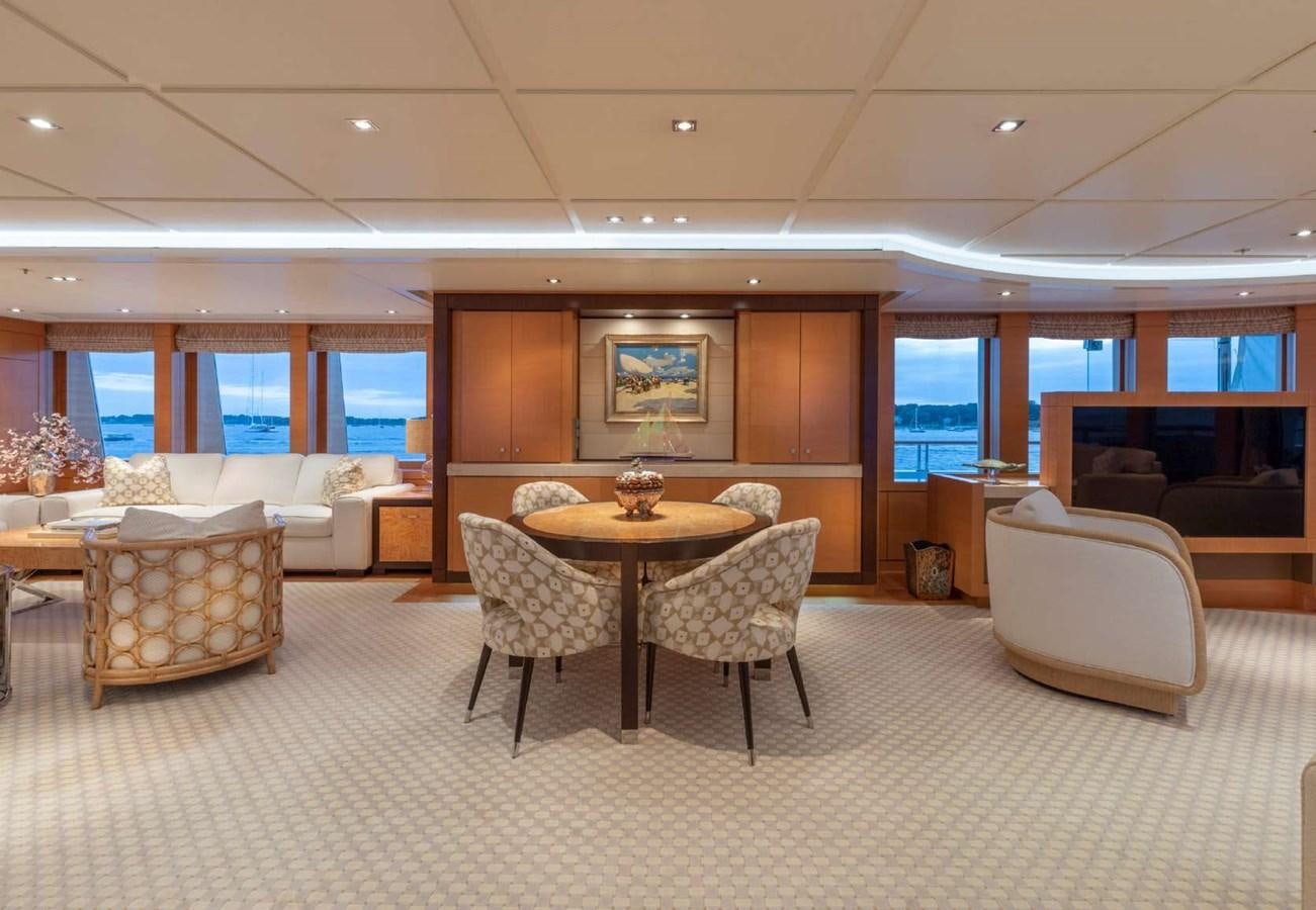 a large room with a table and chairs aboard BELLA VITA Yacht for Sale