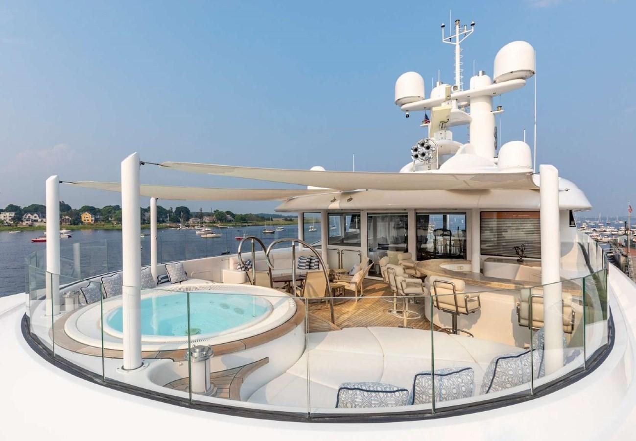 a large white boat with a white tower on the water aboard BELLA VITA Yacht for Sale