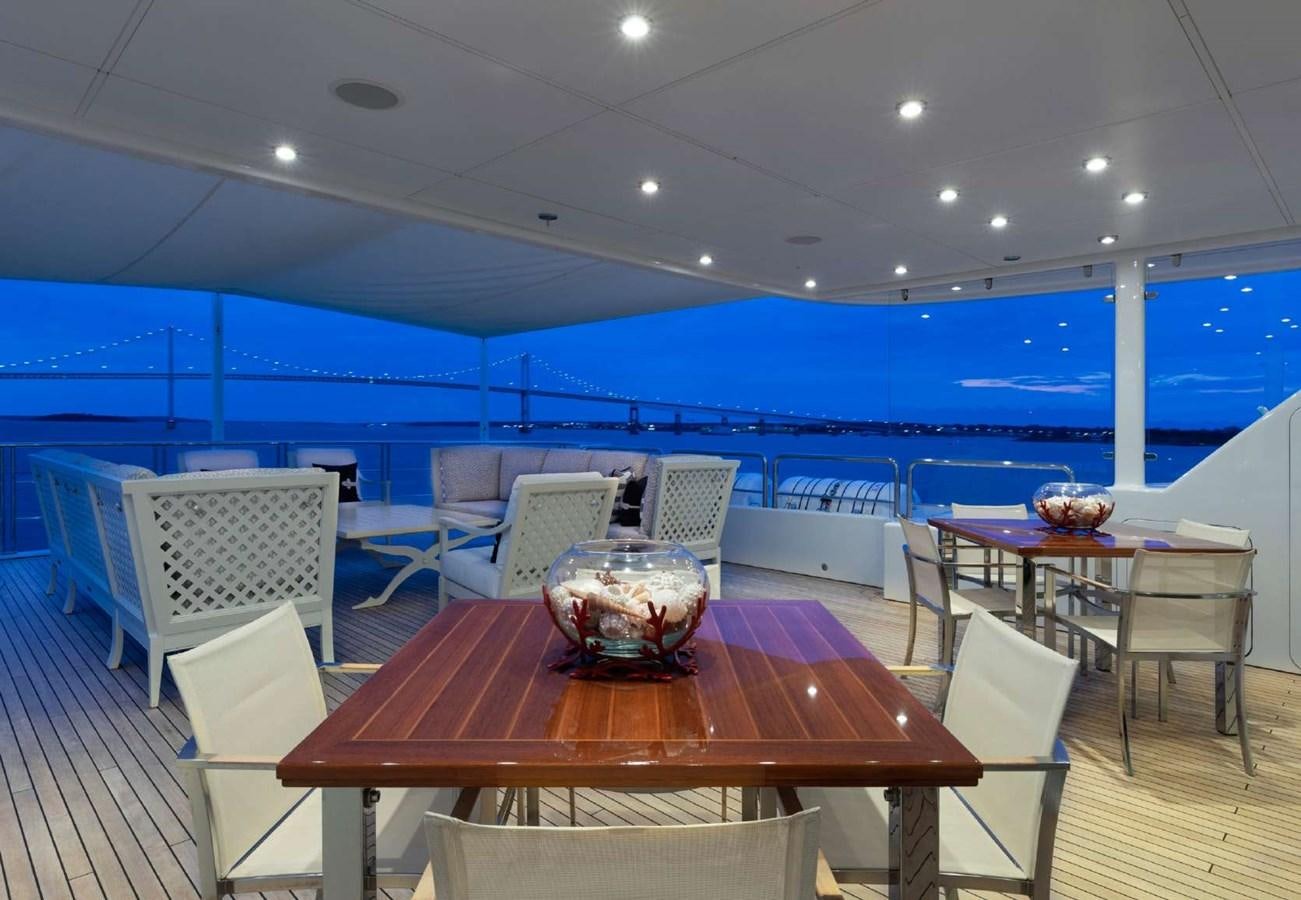 a pool with a table and chairs aboard BELLA VITA Yacht for Sale