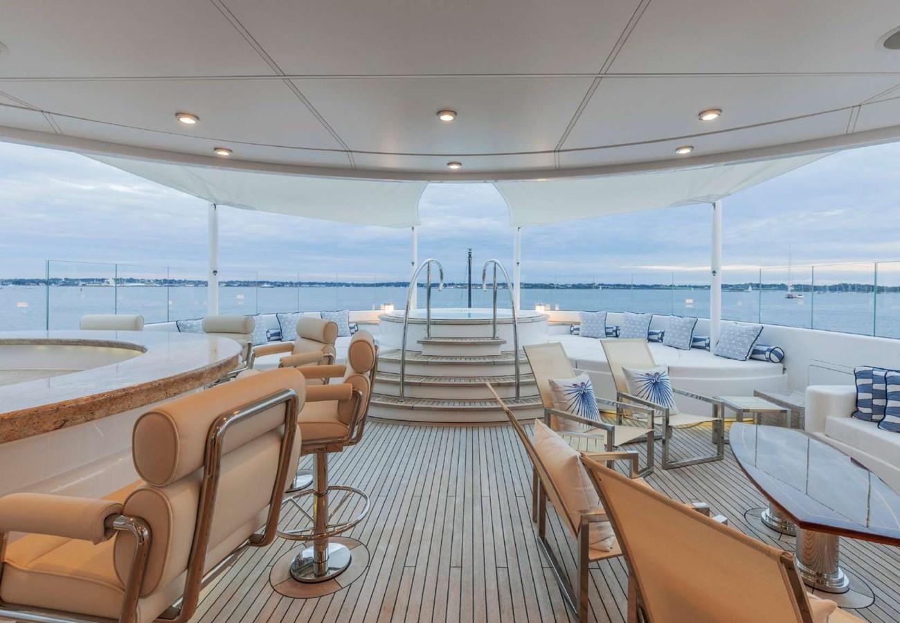 a room with chairs and tables aboard BELLA VITA Yacht for Sale