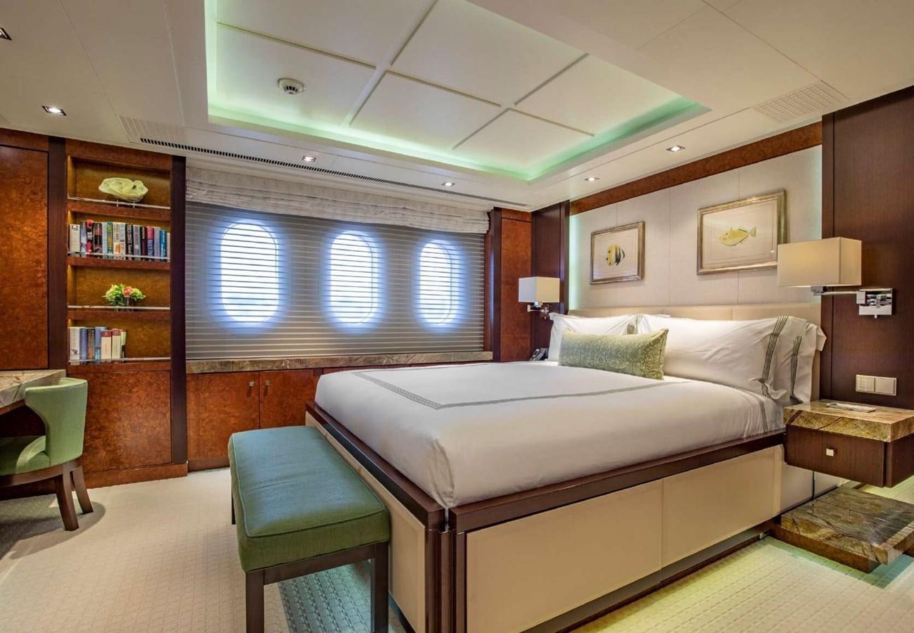 a bedroom with a bed and a bookcase aboard BELLA VITA Yacht for Sale