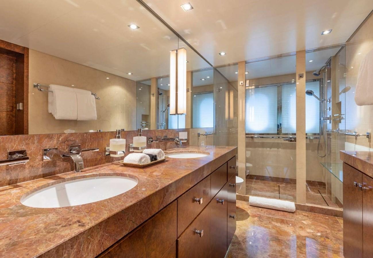 a bathroom with a countertop sink and a large mirror aboard BELLA VITA Yacht for Sale