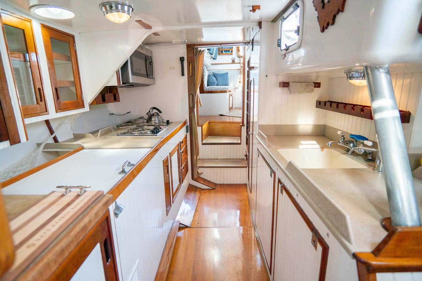 a kitchen with a sink and stove aboard PIAFFE Yacht for Sale