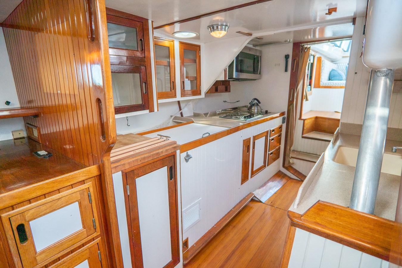 a kitchen with wooden cabinets aboard PIAFFE Yacht for Sale