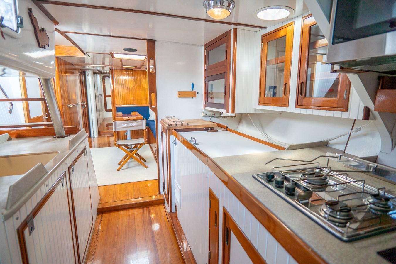 a kitchen with wooden cabinets aboard PIAFFE Yacht for Sale